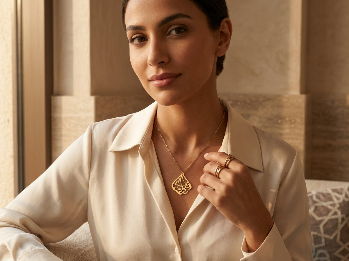 Middle Eastern woman wearing 18K gold Arabic calligraphy name necklace as everyday jewelry