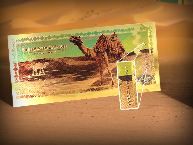 24K gold note souvenir with unique serial number L2A81NWC on desert sand